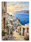 Santorini beyaz evleri ve mavi deniz manzaralı taş sokak tablosu.